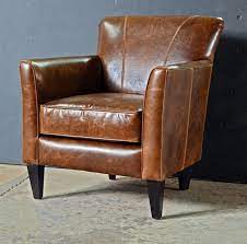 These large, cushioned chairs usually come in leather, adding a luxury layer of relaxation to any household. Wallace Classic Leather Club Chair From Abacus Furniture Handcrafted In Canada Available In Other Fabric White Leather Chair Furniture Leather Club Chairs