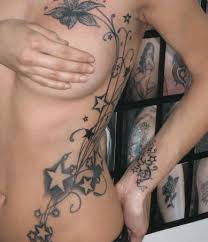 A black smudge tattoo is covered with a big colorful flower tattoo with shades. Breast Tattoo Designs With Pictures 40 Designs