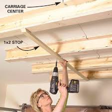 Overhead garage ceiling storage diy. How To Diy A Ceiling Garage Storage System Garage Storage Systems Garage Ceiling Storage Overhead Garage Storage