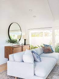 The main sofa remains low and plainly cushy, as mid century modern living room mostly portrays. Amber Interiors Before After Client Of The Mid Century Mid Century Living Room Minimalist Living Room Modern Minimalist Living Room