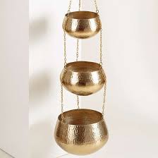 This gold planter has a beautiful shine. 7 Hanging Plant Pots To Give Your Plants A Stylish Edge