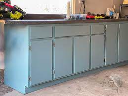 Wood cabinets are ideal for painting, but any surface that can be scuffed with sandpaper can be painted. How To Paint Veneer Cabinets For A Long Lasting Finish Anika S Diy Life