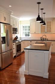 White cupboard with silver handles. White Kitchen Cabinets Black Countertop Red Oak Floor Google Search Oak Floor Kitchen Kitchen Flooring Kitchen Tiles Design