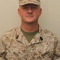 Gunnery Sgt. Maurice Williams teaches children how