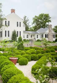 Garden Tour A Jewelry Designer S Gothic Style Greenhouse Is An Anglophile S Dream Boxwood Garden Traditional Landscape Garden Tours