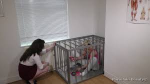 Caged Slave Girl Blows Up Balloons