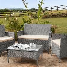 Seats and footrests can be concealed under the table when not in use. 4 Piece Rattan Garden Furniture Set