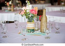 Here are a few terms you will hear your wedding planner or designer say when referring to setting your reception tables. Wedding Reception Table Centerpieces Diy Wedding Decor Table Centerpieces With Wine Bottles Wrapped In Burlap Twine And Rose Canstock