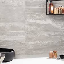 Done in simplistic river rock cement accented by the smooth profiles of the matte black telephone shower. Basic Travertine Silver 12x24 Matte Porcelain Tile Tilebar Com