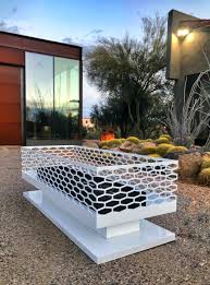 Has a circular design of natural fitted stones with a gray slate top. Modfire Modern Outdoor Fireplaces