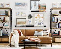 A colorful framed photo of a farm hangs cheerfully between them. What To Put On The Blank Wall Over Sofa