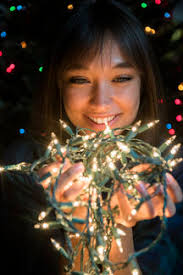 Check spelling or type a new query. Mixed Race Woman Holding String Lights Near Christmas Tree Stockphoto