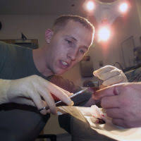 US Navy (USN) Hospitalman Third Class (HM3) Steven Paige, Branch Medical  Clinic, MCAS Yuma, sutures another stitch into the finger of US Marine  Corps (USMC) Sergeant (SGT) Francisco Gutierrez, Combat Visual Information