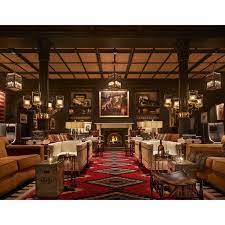 Lounge At Hotel Jerome In Aspen Features Hanging Blake Lanterns With Mesh By Charles Edwards Aspen Hotel Hotel Fireplace Seating