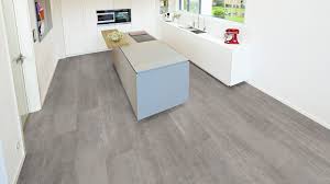 Rubber flooring has nonslip quality, perfect for a busy kitchen. Ter Hurne Cement Look Light Grey Laminate Tile Wood4floors