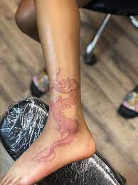 Large Red Dragon Leg And Ankle Tattoo What Does A Dragon Symbolize Leg Leaning On Black Leat Dragon Tattoo For Women Dragon Thigh Tattoo Dragon Tattoo Ankle