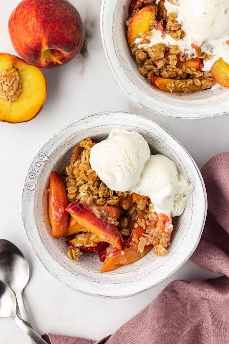 Perfect Peach Crisp served with a scoop of vanilla ice cream