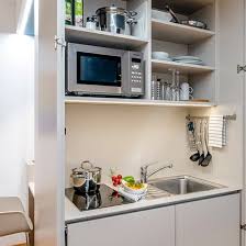 In some motel and hotel rooms, small apartments, college dormitories, or office buildings, a kitchenette consists of a small refrigerator, a microwave oven, and sometimes a sink. Design Rooms Kitchenette In Wels Boutique Hotel Hauser