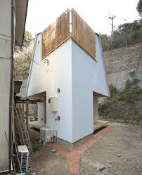 To the right of the entry is a large pantry with plenty of shelf space which serves the adjacent kitchen. Armadillo By Yuji Tanabe Is Built On Diamond Shaped Plan