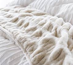 The tache elegant faux fur throw blanket comes in several sizes, including an oversized option that's perfect for cuddling with a partner or pet. Faux Fur Ruched Throw Blankets Pottery Barn