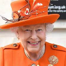 A Close Up Of Queen Elizabeth Ii Wearing An Orange Hat And Coat At The Science Museum In England Queen Elizabeth Ii Queen Elizabeth Queen Makeup