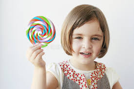Little Girl Holding a Big Candy Stock Image