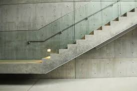 Glass Railing Across From Metal Railing Against Gray Background Frameless Glass Balustrade Glass Railing Stairs Glass Stairs