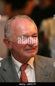 Former National Football League Player Brian DeMarco, center, is helped to  the podium by former players Conrad Dobler, left, and Daryl Johnston during  a news conference explaining the state of affairs for