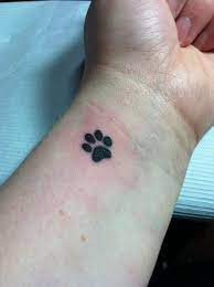 Paw tattoos can have various meanings like memory of a pet, movement/moving forward, totem animal, ferocity, power and strength, children and both small and large paw print tattoos looking pretty good on the wrist and you get to see your pup's paw all the time. Paw Tattoos Designs And Ideas Page 4 Inner Wrist Tattoos Tattoos Pawprint Tattoo
