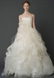 A ball gown wedding dress features a fitted bodice paired with a wide and full skirt. Vera Wang
