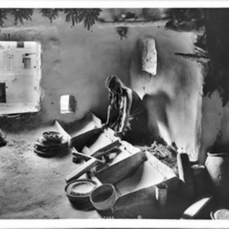 Young Hopi Indian woman grinding corn for flour, ca.1900 — Calisphere