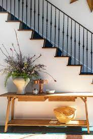 The space under the stairs provides just the right depth for a comfy bench and bookshelf. 19 Console Table Decorating Ideas For Every Room In The House