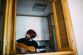 Knitted magic gloves, red or black; Cheerful Bearded Man In Knitted Hat Playing Acoustic Guitar At Home Art Object Caucasian Stock Photo 171146154