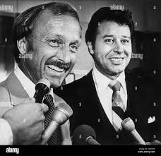 Former University of New Mexico basketball coach Norm Ellenberger, left,  talks to reporters following his acquittal