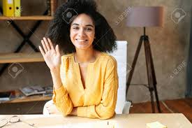 Video Chat With Attractive African American Female Colleague, She Is  Greeting. Online Meeting With A Multi Ethnic Woman Sitting At Modern Office  Stock Photo, Picture And Royalty Free Image. Image 157427622.