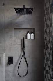 Matte Black Accents Add Sophistication To This Grey And White Bathroom Modern Bathroom Bathroom Shower Tile Shower Heads