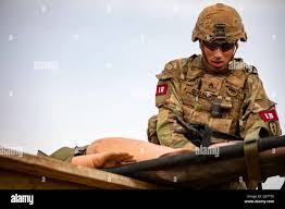 Staff Sgt. Abel Carlos, Combat Medic Specialist, 25th Infantry Division,  carry a skid litter during an physical training exercise for the Army's  Best Medic Competition. Twenty-two two-Soldier teams from all around the