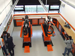 Ktm Husqvarna Motorcycle Brands Lv8 Elevate Sorbolo Motorcycle Showroom Interior Garage Interior Cool Garages