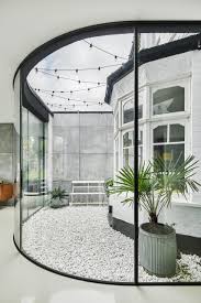Check spelling or type a new query. This Home Extension Wraps Around A Bay Window Creating A Small Courtyard