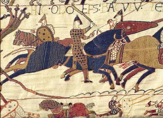 A long, embroidered cloth showing detailed historical scenes from 1066.