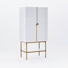 Its unique design is features ample storage and brushed brass legs. Downing Bar Cabinet White Antique Brass