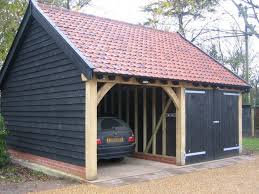 A Black Wooden Garage With Carport Find More Information On Www Pineca De Holzgaragen Cars Carphotos Black Timber Garage Garage Construction Wooden Garage