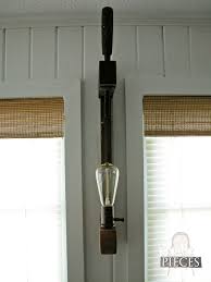 A wall sconce fight fixture made with mid century modern industrial pipes and hurricane glass lamp shades. Diy Farmhouse Lighting Kitchen Remodel Continues Prodigal Pieces