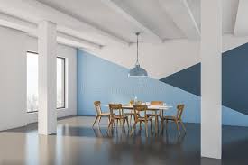 Dark blue painted dining room walls accent white and blue camelback dining chairs placed around a round wooden dining table placed on a bound sisal rug lit by a brass greek key chandelier. Blue Dining Room White Stock Illustrations 2 840 Blue Dining Room White Stock Illustrations Vectors Clipart Dreamstime