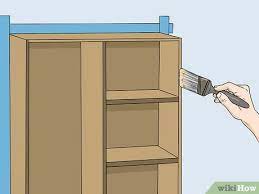 Paint them, put in glass doors or leave them as they are now. How To Refinish Particle Board Cabinets With Pictures Wikihow