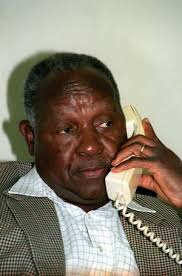 Image of Defence Minister Joe Modise ponders a point at a press