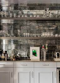 Brimming with views of the outdoors, the gentle green tiles also bring a touch of nature into the kitchen work space. Gray Wet Bar With Antiqued Mirror Subway Tile Backsplash Contemporary Kitchen