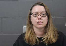 Woman charged for trying to stab her children in a car driving