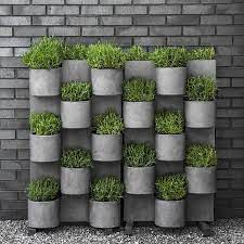 Lush plantings, trailing vines and billowing grasses can soften the hard edges of a contemporary gate to create a more inviting entrance. 33 Cool Vertical Garden Design Ideas 20 33decor Vertical Garden Systems Vertical Herb Garden Large Vertical Garden