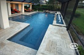 Www Pbjc Com The Rock On The Walls Is Real Stone And The Water Bowl Spills On All Sides With A Fire Bu Pool Designs Luxury Swimming Pools Swimming Pool Builder